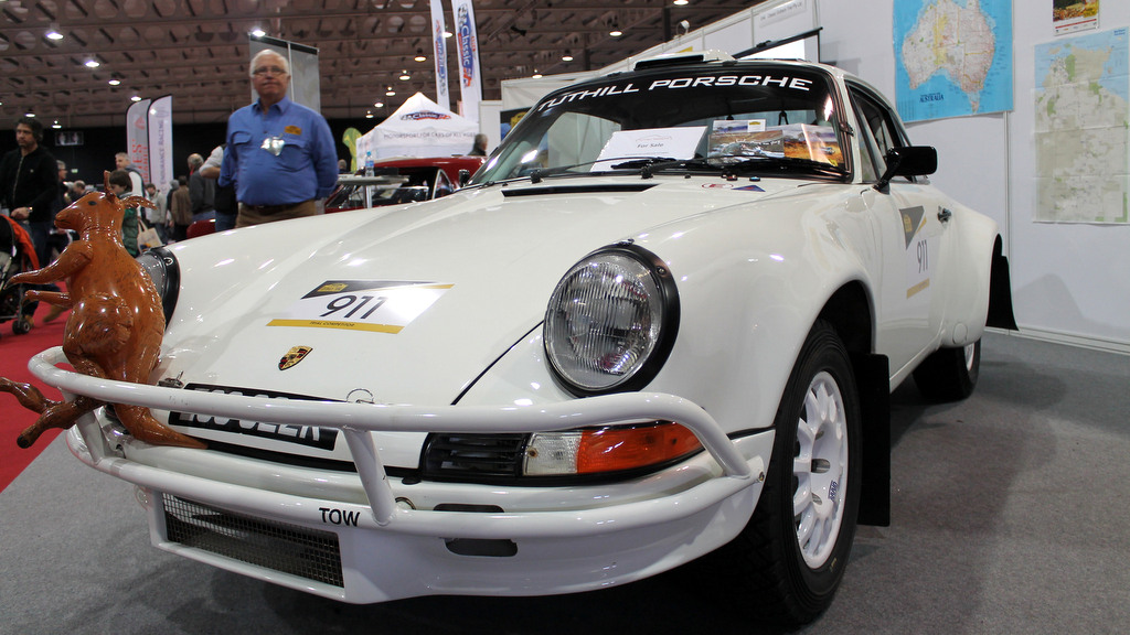 White Porsche rally car with a "for sale" sign