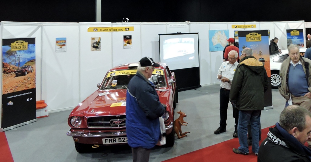 The COT stand at Race Retro with visitors talking to Ian
