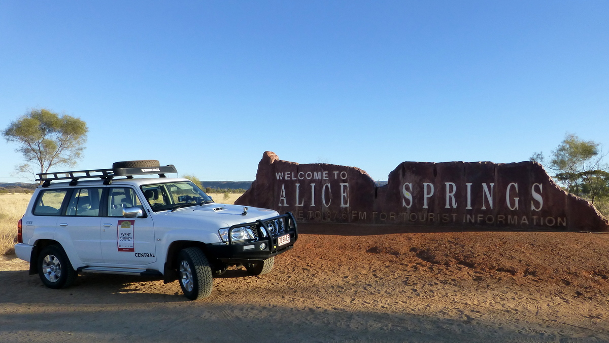 Survey car parked in front of the Welcome to Alice Springs sign
